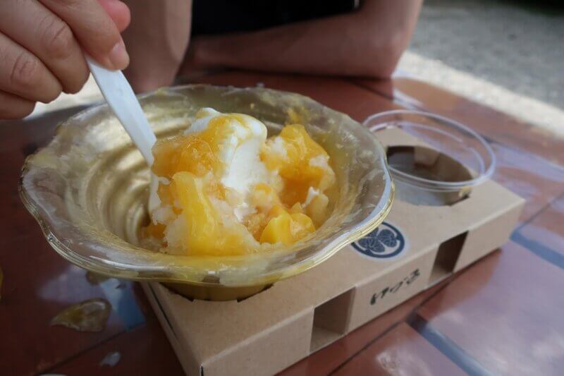 マンゴー味のかき氷を食べ進めた写真